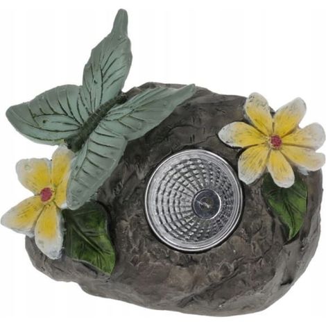 Lámpara solar de jardín con forma de mariposa sobre una piedra de 10 cm.