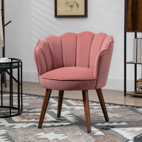 Fauteuil capitonné en velours rose, avec dossier coquillage et pieds en bois, idéal pour le salon et la chambre. Dimensions : 66 x 66 x 78,5 cm. Couleur : rose.