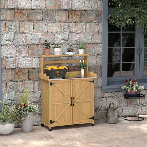 Mesa de jardinería con armario y estantes, y patas antideslizantes en la parte superior, fabricada en madera de abeto amarillo.