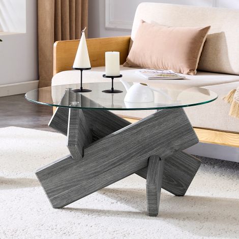 Table basse ronde (MDF + Verre) — Plusieurs coloris au choix : Pieds de support créatifs en forme de croix, à la texture grise — à la fois simples et élégants. Plateau en verre trempé d'une épaisseur