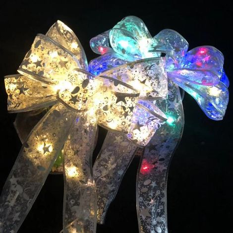 Leuchtende, transparente Weihnachtsfliege, große silberbedruckte Zierschleife für den Weihnachtsbaum, mit Lichterkette. (1/5)
