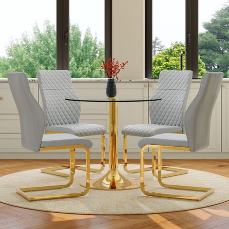 Set de salle à manger : table ronde en verre diamètre 85 cm, design raffiné, piètement métal doré, avec 4 chaises modernes gris clair et doré. (1/5)