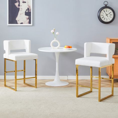 Un ensemble de deux tabourets de bar de style nordique, dotés d'un design carré moderne et de pieds en métal doré, offrant une assise légère et confortable.