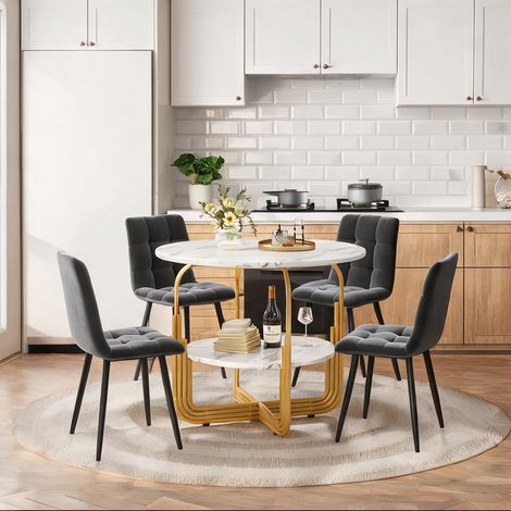 Table à manger ronde dorée avec chaises grises en velours (1/5)