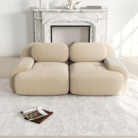 Canapé modular de esquina en pana beige, sin estructura, con reposabrazos curvos y base antideslizante