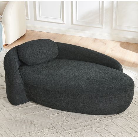 Divano nero in Lammfell-Optik con cuscino, design arrotondato, soffice e compatto (1/5)