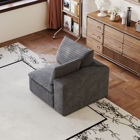 Canapé modulaire en tissu gris foncé, assise en mousse complète, configuration flexible pour salon et studio