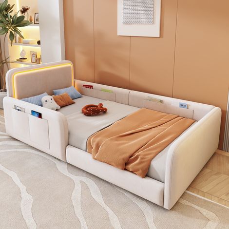 Cama infantil de 90x200 cm con iluminación LED controlada por app, bolsillos de almacenamiento, somier de láminas y tapizado en terciopelo beige. (1/5)