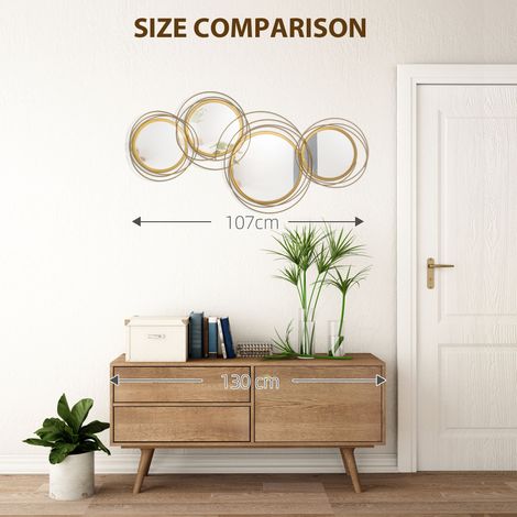 Miroir rond décoratif mural en métal avec cadre doré, 107 cm de largeur x 56 cm de hauteur - Sculpture suspendue pour salle de bain, salon, chambre ou salle à manger (1/5)