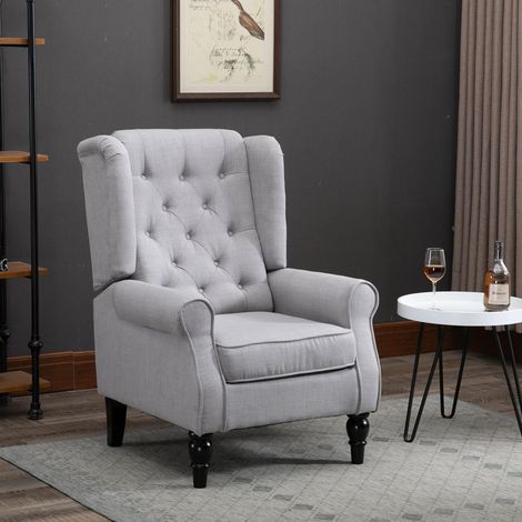 Fauteuil de chambre de style français avec assise large, capitonné, avec accoudoirs et rembourrage, pieds en bois, gris, idéal pour le salon et le bureau.
