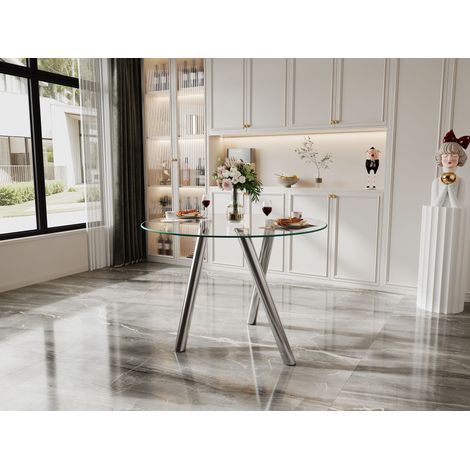 Mesa de comedor redonda de cristal templado con una estructura metálica plateada estable y fácil de limpiar. (1/5)