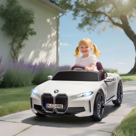 Auto elettrica per bambini BMW i4 12V con licenza ufficiale, telecomando, lettore MP3, musica, luci e cintura di sicurezza, 115x67x45 cm, nera.