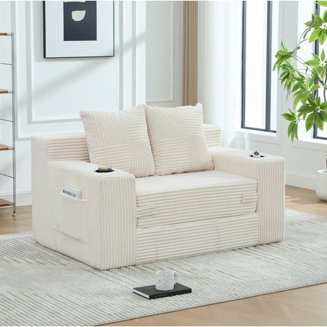 Sofá beige de terciopelo acanalado con cojines, bolsillos laterales y reposabrazos, CHICFURN, asiento acolchado para lectura, descanso y rincón de salón moderno (1/5)