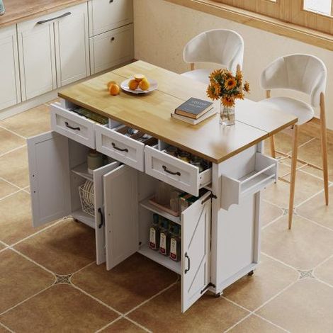 Îlot de cuisine avec plan de travail rabattable, équipé de 5 roulettes avec freins, 4 portes de placard, 3 tiroirs et porte-serviettes de chaque côté  style portes de grange, finition blanche.