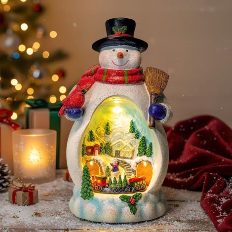 JSSEVN - Weihnachtsdorf mit Lichtern und Musik. Beleuchtetes LED-Haus. Eisenbahn-Design mit Musik. Spieluhr (Schneemann). (1/5)