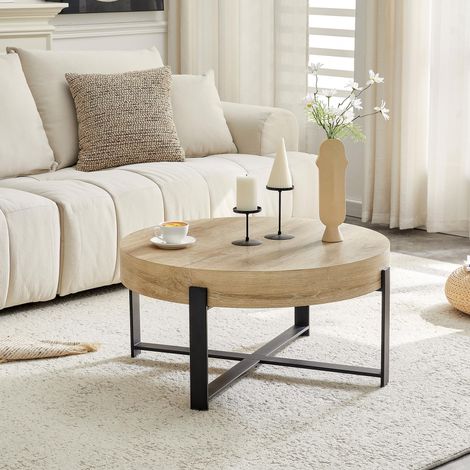 Table basse ronde (68 cm de diamètre) de style industriel rétro. Plateau en MDF à grain de bois naturel, piètement croisé en métal noir, idéale pour un style wabi-sabi/industriel. (1/5)