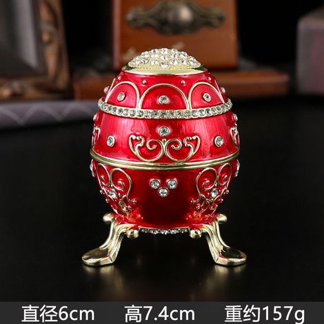 Boîte à bijoux en forme d'œuf, en métal émaillé rouge, incrustée de diamants, avec couvercle à charnière et protection anti-poussière. (1/2)
