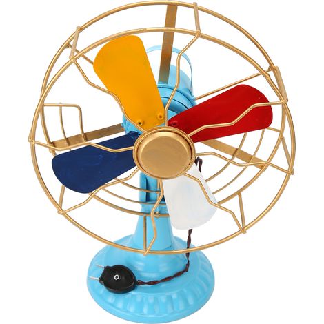 Ventilateur électrique vintage en fer forgé, aspect vieilli et coloré, idéal pour décorer une entrée ou une vitrine. (1/5)