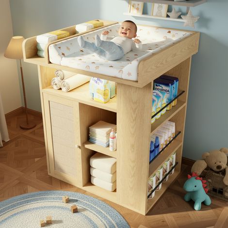 Table à langer bois tons naturels éclairage LED réglable,vaste rangement latéral et espace aménagé avec cloisons.