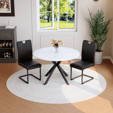 Set de comedor con mesa redonda efecto mármol blanco y 4 sillas negras de PU (1/5)