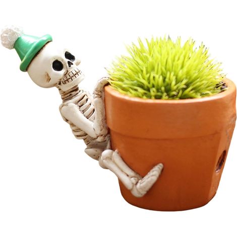 Maceta con forma de calavera: esqueleto tumbado para decorar el jardín. (1/5)