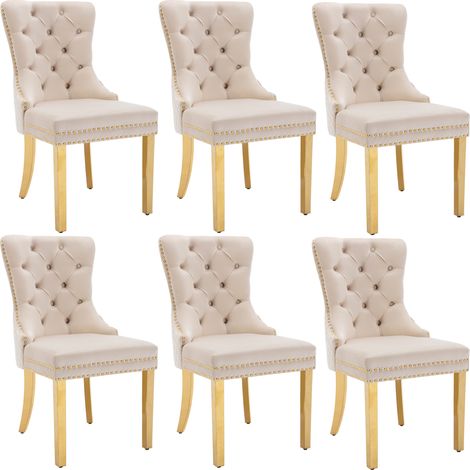 Silla de comedor tapizada beige con respaldo decorativo y patas de acero inoxidable dorado (1/5)