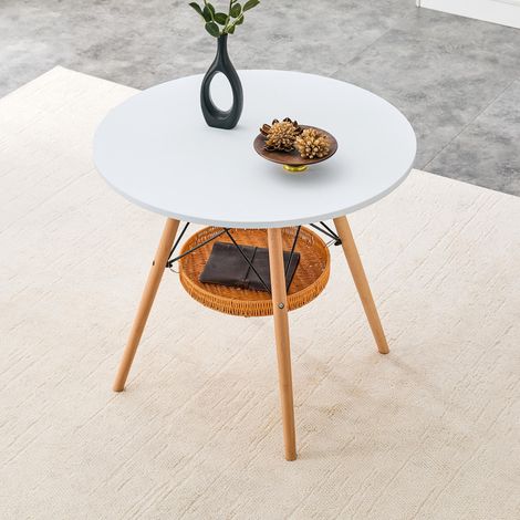 Table de salle à manger ronde Ø 80 cm, plateau en MDF blanc, pieds en bois massif, combinée à une structure de rangement flottante en panier tressé, convient pour 2 à 4 personnes.