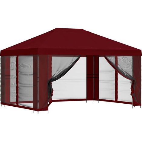 Ce chalet de jardin possède des murs de 4 x 3 mètres, est peint en rouge bordeaux et est construit en fibre de polyester et en acier. (1/5)