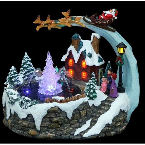 Scena luminosa con Babbo Natale e fontana
