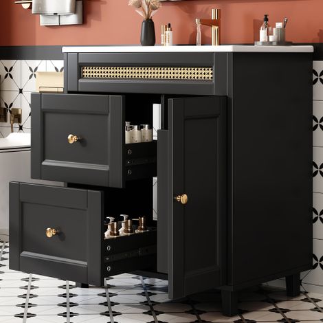 Meuble de salle de bain autoportant 76×46×86,5 cm, deux tiroirs à glissières silencieuses, portes avec fermeture douce, poignées dorées et décorations en rotin, lavabo en céramique, noir