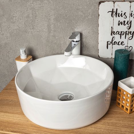 Lavabo da appoggio rotondo in ceramica ELYNA con interno dal design a forma di diamante.