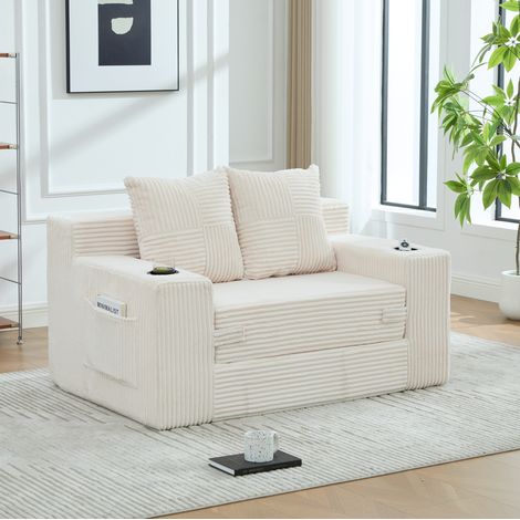 Canapé lounge 151/133/64 cm en velours côtelé beige avec 2 coussins et poches latérales (1/5)