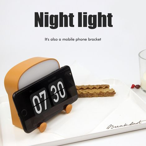 Wiederaufladbares und tragbares LED-Nachtlicht in Form eines Toasts mit Handyhalterung aus Silikon. (1/5)
