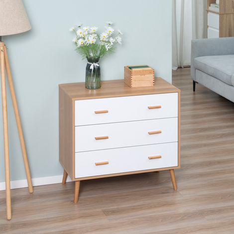 Cómoda de diseño escandinavo con patas, tres cajones deslizantes, patas cónicas en ángulo y tablero de partículas blanco con aspecto de madera clara.