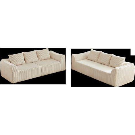 Ein minimalistisches Sofa aus Cord mit fließenden, geschwungenen Linien, einer sanft abfallenden Rückenlehne und sechs Kissen. (1/5)