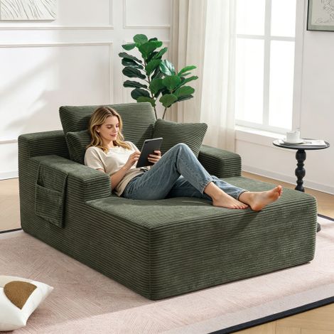 Un comodo divano in velluto a coste, che non richiede montaggio, con morbidi cuscini per schienale e seduta e tasche laterali per riporre telecomandi e cellulari: un design semplice ed elegante. (1/5)