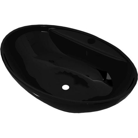 Lavabo ovale avec trop-plein et robinet en céramique, adapté à une utilisation en salle de bain.