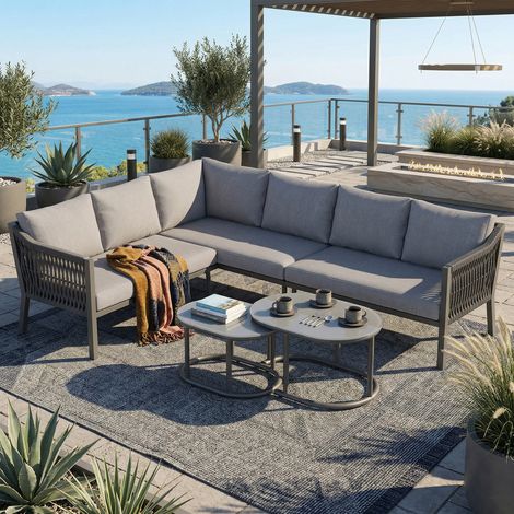 Ensemble jardin angle 6 personnes fer galvanisé plateau verre,composition modulable tables basses et canapé gris.