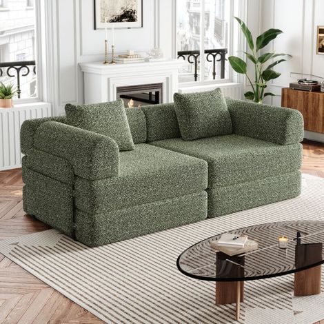 Grün 4-in-1-Schlafsofa aus Fleece mit Aufbewahrungsfach in der Armlehne, drei Metallrahmen und mehreren Konfigurationsmöglichkeiten.
