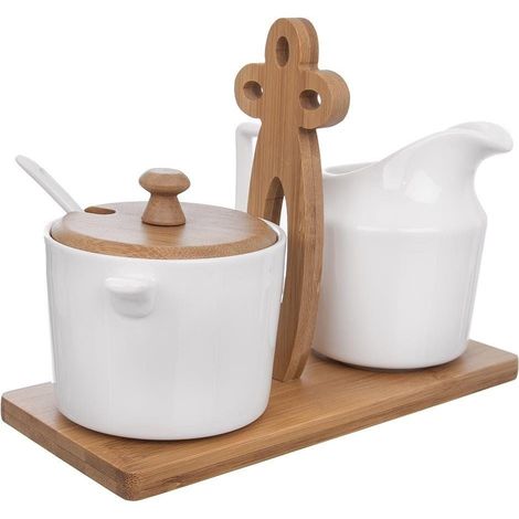 Elegant porcelain sugar bowl and cream jug on bamboo tray (1/5)