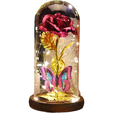 Lampe rose plaquée or avec bande lumineuse LED et pétales tombés dans un dôme en verre sur une base en bois
