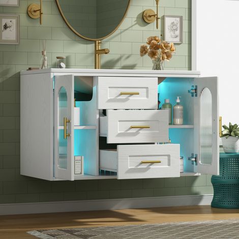 Meuble de salle de bain mural de 76 cm avec lavabo, aspect bois blanc, porte en verre cannelé, éclairage LED, étagères et tiroirs réglables, meuble bas moderne, sans robinetterie. (1/5)