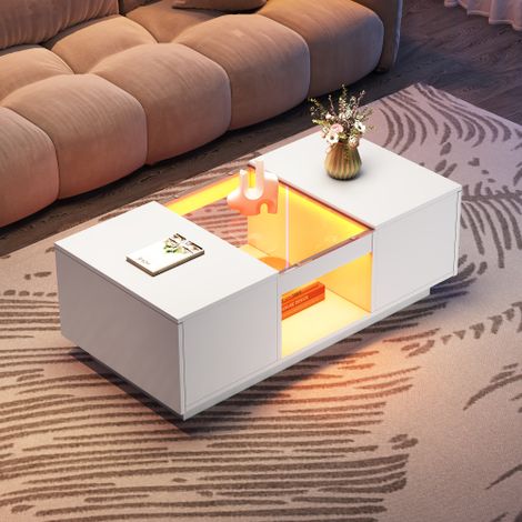 Table basse blanche — dotée d'un panneau en verre, d'un éclairage LED, d'une fonctionnalité de contrôle via application mobile, de deux tiroirs et d'un compartiment de rangement ouvert.
