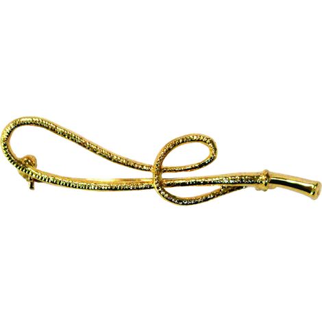 Broche plastron avec fouet et finition dorée