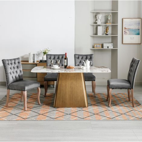 Silla de comedor tapizada en terciopelo gris con respaldo curvado, tachuelas decorativas y patas de madera, estilo moderno, cómoda y elegante de CHICFURN (1/5)