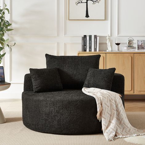 Poltrona monoposto, non richiede montaggio, con cuscino cilindrico sullo schienale, in tessuto ciniglia nero, ideale per soggiorno o camera da letto. (1/5)