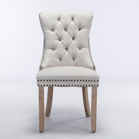 Collection Nikki : 2 chaises haut de gamme lin rembourré,pieds bois,cloutées,couleur beige,style moderne et intemporel.