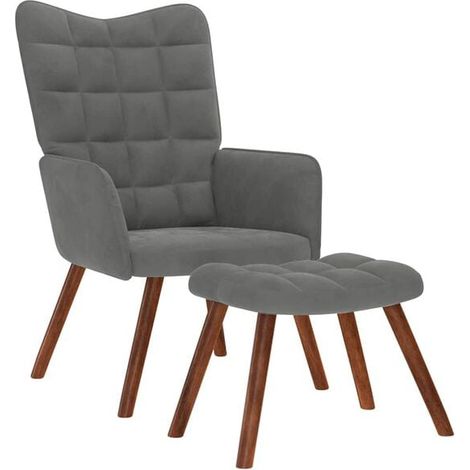 Un fauteuil décontracté en velours gris foncé, avec un repose-pieds. (1/5)