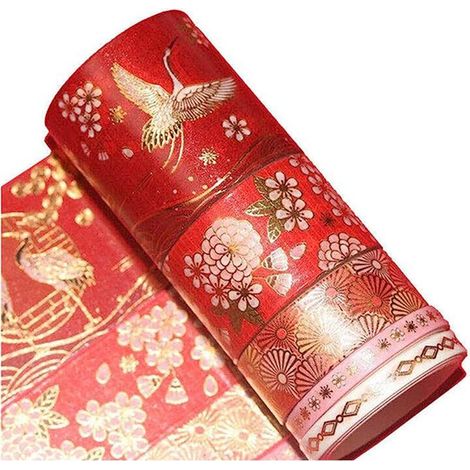 Schachtel mit 5 Rollen goldenem Band mit Feenkranichmotiven. Dekoratives Band für Fotoalbumränder. (1/5)