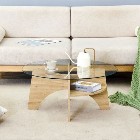 Table basse ronde moderne en verre — Dotée d'un plateau transparent et d'un design polyvalent. Piétement en éventail avec pieds en MDF effet bois naturel. Un choix idéal pour le salon.